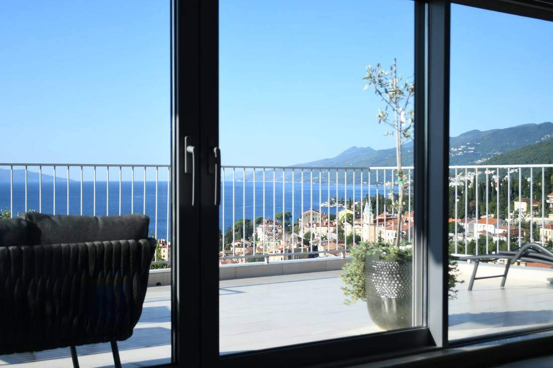 Baie vitrée ouverte sur une terrasse avec vue mer